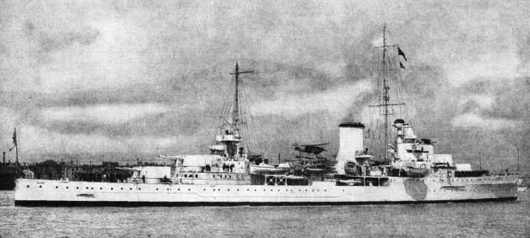 H.M.S. AJAX. This ship has a displacement of 7,030 tons, an overall length of 554½ ft and a beam of 55 ft 2-in
