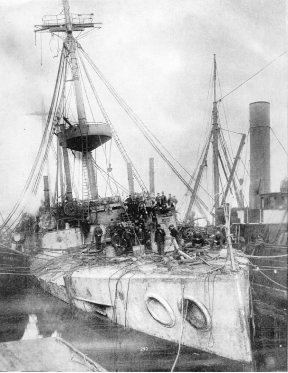 The cruiser Gladiator, supported by salvage tugs
