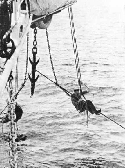 SECURING THE CABLE which the specially-designed grapnel has raised from the sea-bed